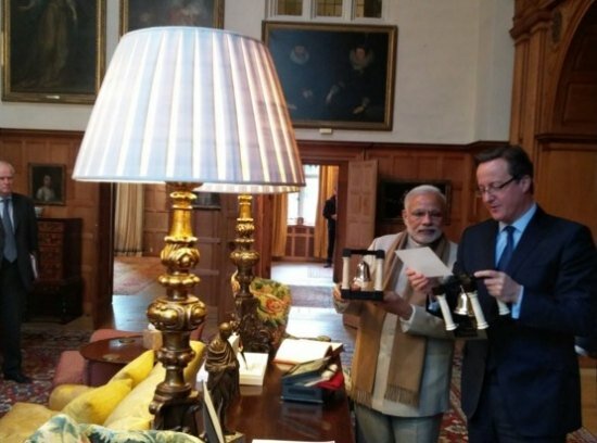 Narendra Modi UK visit 2015: Pics of electric atmosphere at Wembley Stadium for 'UKWelcomesModi' community reception Modi presenting Cameron with a pair of 'book ends' made of wood, marble and silver as a gift for the host